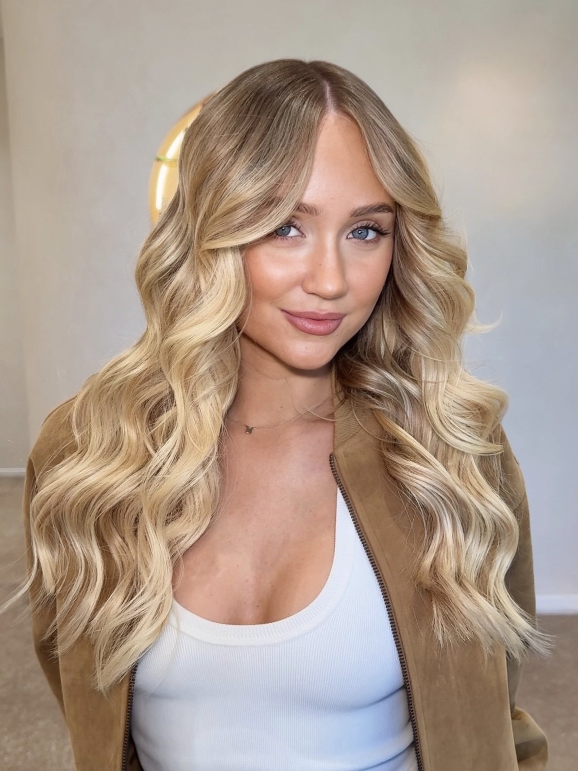 Long blonde Perlino hair extensions styled in loose waves at Jessica Amanda Hair Artistry, Perth